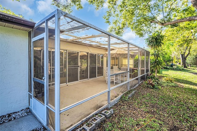 exterior space featuring glass enclosure and a patio area