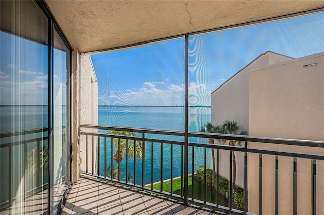 unfurnished sunroom featuring a water view