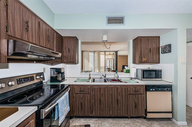 kitchen featuring visible vents, appliances with stainless steel finishes, a textured ceiling, under cabinet range hood, and a sink