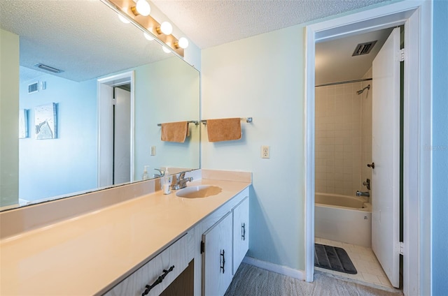 full bathroom with baseboards, visible vents, a textured ceiling, and vanity