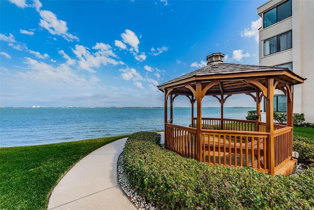 view of property's community with a water view and a gazebo