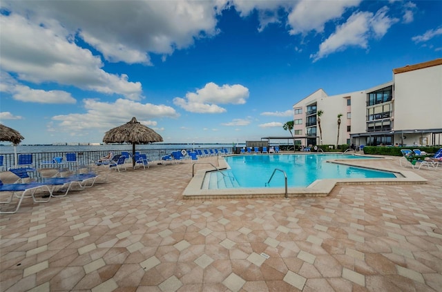 community pool featuring a water view and a patio