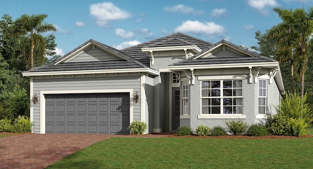 view of front facade featuring decorative driveway, an attached garage, a front yard, and stucco siding