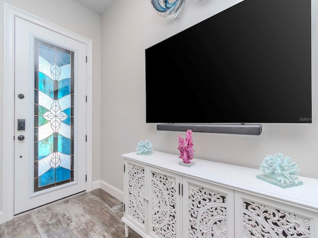 entryway with baseboards and wood finished floors