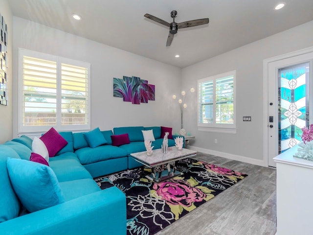 living area featuring a ceiling fan, recessed lighting, baseboards, and wood finished floors