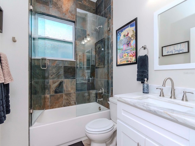 full bathroom with shower / bath combination with glass door, vanity, and toilet