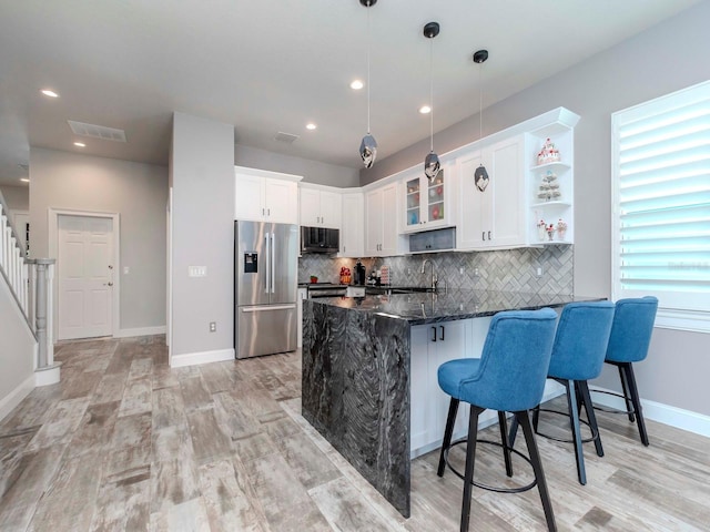 kitchen featuring tasteful backsplash, visible vents, appliances with stainless steel finishes, a peninsula, and open shelves