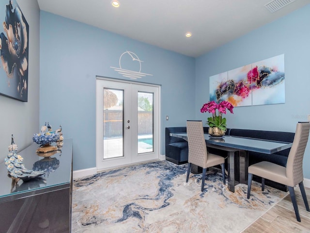 dining space featuring french doors, wood finished floors, visible vents, and recessed lighting