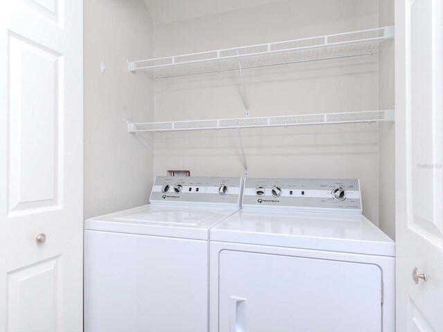 washroom with laundry area and washer and dryer