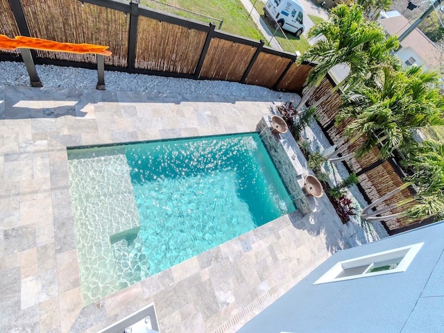 view of pool featuring fence