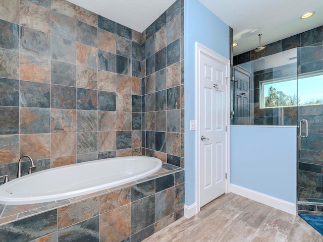 bathroom featuring a stall shower, tile walls, and a bath