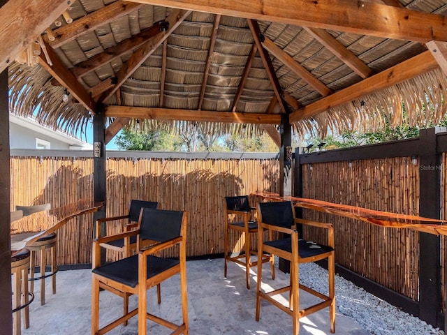 view of patio with fence and a gazebo