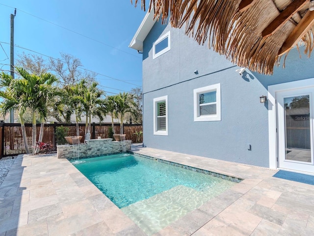 view of swimming pool with a patio, fence, and a fenced in pool