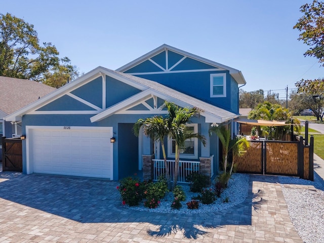 view of front of property featuring a garage, covered porch, fence, and stucco siding