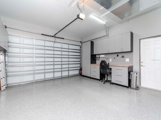 5526 14th Ave S, Gulfport, FL 33707 - garage with a desk and a garage door opener
