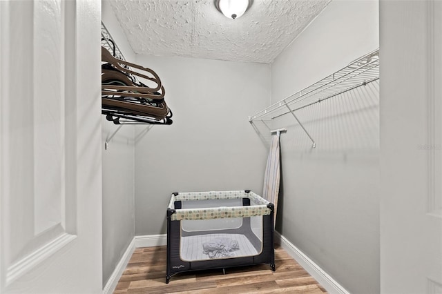 walk in closet featuring wood finished floors