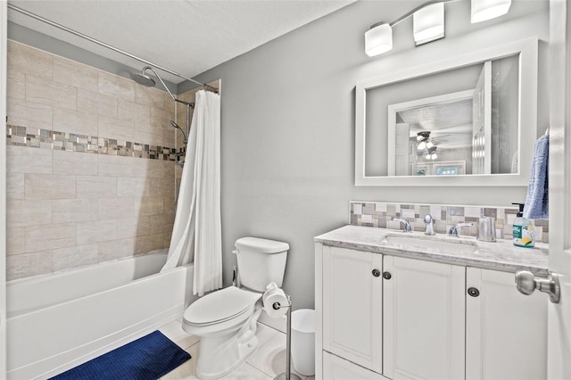 bathroom with toilet, vanity, a ceiling fan, tile patterned floors, and shower / tub combo with curtain