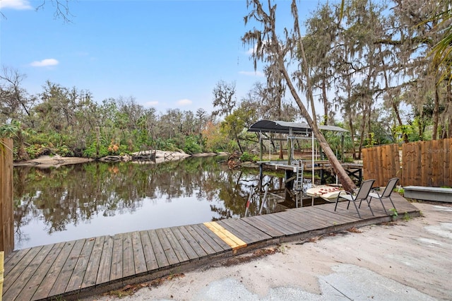 dock area with a water view and boat lift