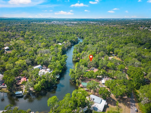 drone / aerial view featuring a water view and a view of trees