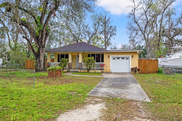 view of front of house featuring an attached garage, covered porch, driveway, stucco siding, and a front lawn