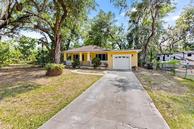 view of front of house featuring driveway, an attached garage, fence, a front lawn, and stucco siding