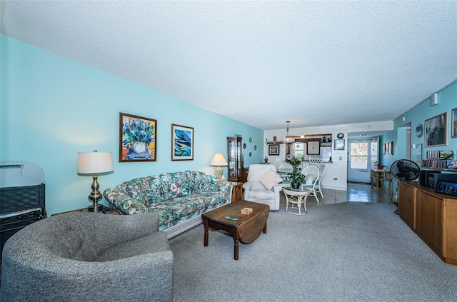 carpeted living area with a textured ceiling