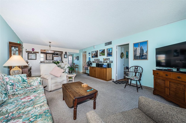 carpeted living area with visible vents and a textured ceiling