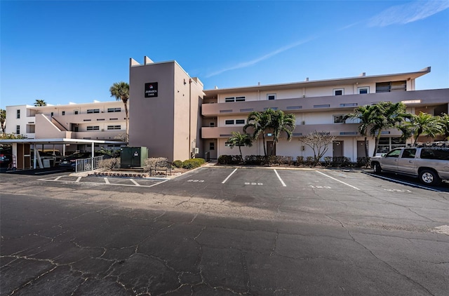 view of building exterior with uncovered parking