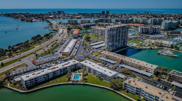 birds eye view of property with a water view and a city view