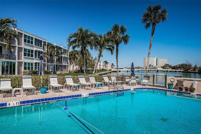 community pool with a water view and a patio