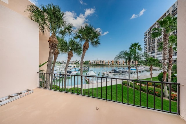 balcony with a water view and a boat dock