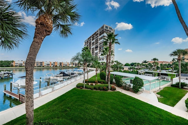 view of dock with a lawn, a water view, and boat lift