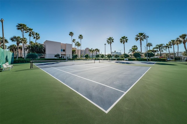 view of tennis court featuring fence