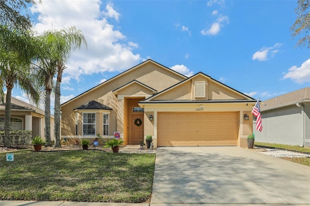 ranch-style home featuring a front lawn, concrete driveway, an attached garage, and stucco siding