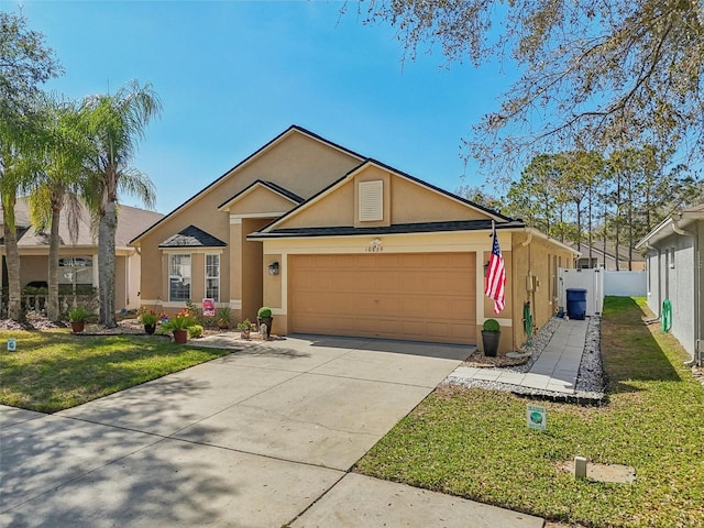 ranch-style house with stucco siding, concrete driveway, an attached garage, fence, and a front lawn