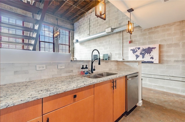 kitchen featuring light stone counters, decorative backsplash, a sink, unfinished concrete floors, and dishwasher