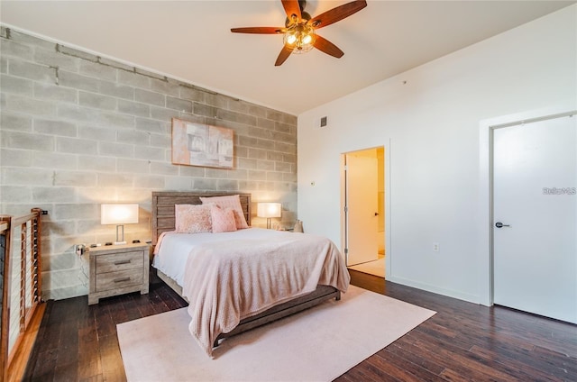 bedroom with visible vents, ensuite bath, baseboards, and hardwood / wood-style flooring