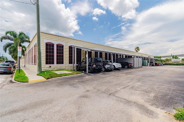 view of building exterior with covered parking