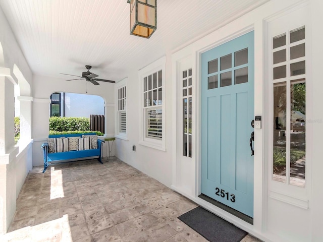 view of exterior entry with ceiling fan