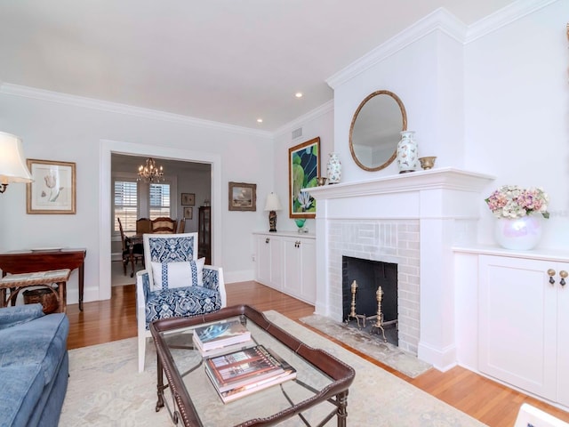 living room with visible vents, baseboards, crown molding, a brick fireplace, and light wood-type flooring