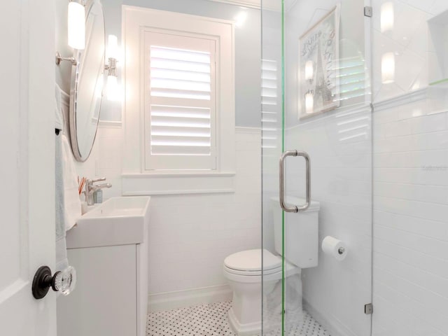 full bathroom with a shower stall, tile walls, vanity, and toilet