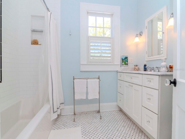 full bath featuring baseboards, shower / tub combo, and vanity