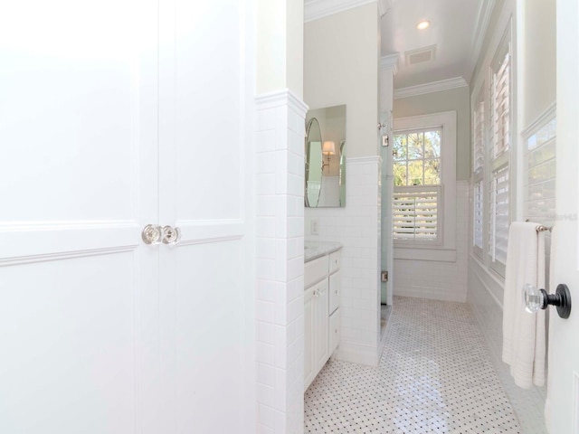 bathroom with vanity, visible vents, a wainscoted wall, recessed lighting, and crown molding