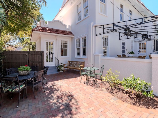 view of patio / terrace featuring entry steps, outdoor dining area, and fence