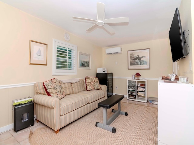 living area with light tile patterned floors, a ceiling fan, a wainscoted wall, and a wall mounted AC