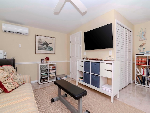 living area featuring light tile patterned floors, baseboards, an AC wall unit, and a ceiling fan