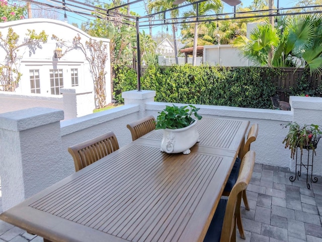 view of patio / terrace with outdoor dining space and fence