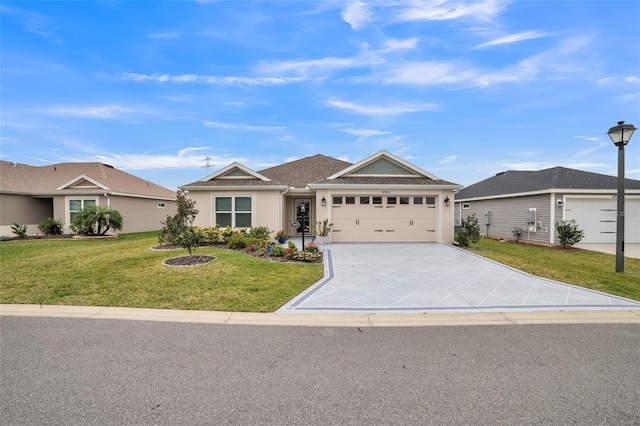 ranch-style house featuring a garage, concrete driveway, a front yard, and stucco siding