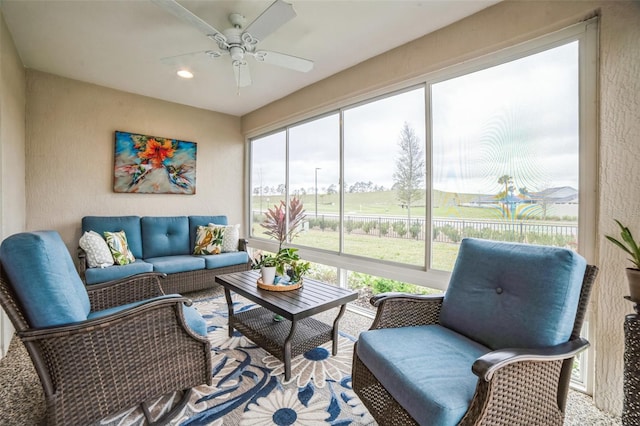 sunroom featuring ceiling fan