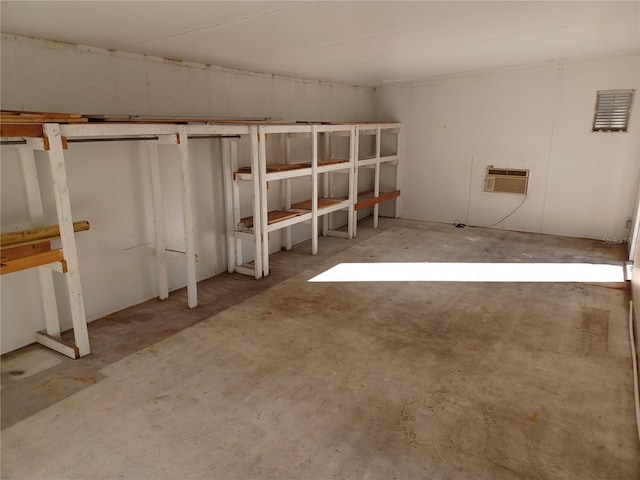 unfinished basement featuring a wall mounted air conditioner